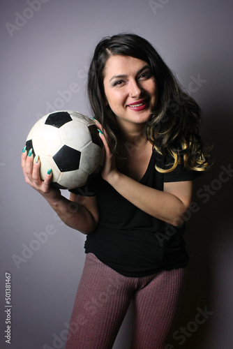 woman with soccer ball making facial expressions