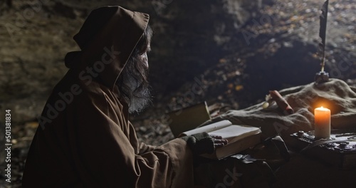 Obraz na płótnie Senior wise man writing with quill