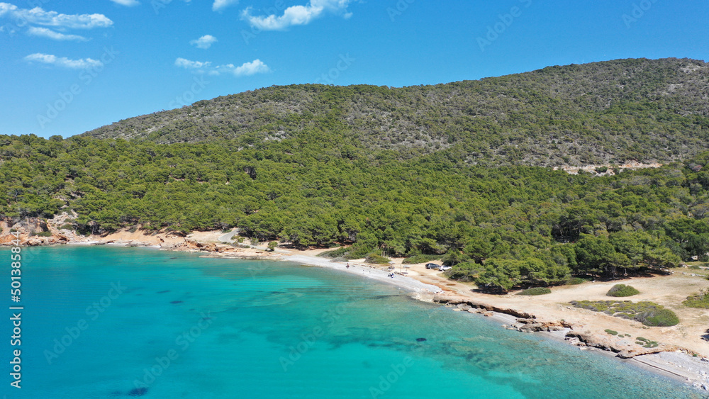 Aerial drone photo of paradise bay and turquoise beach of Dragonera covered in pine trees in small island of Agistri, Greece
