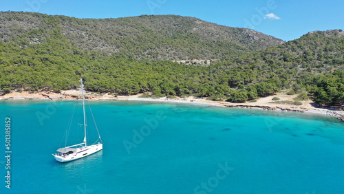 Aerial drone photo of paradise bay and turquoise beach of Dragonera covered in pine trees in small island of Agistri, Greece
