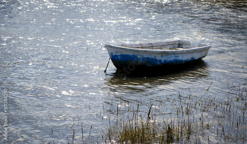 A rowingboat on a sunlit sea symbolising calm photo