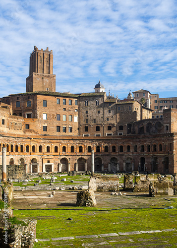 Vertical shot of Trajan's Market in Rome with ancient buildings and ruins under a bright blue sky photo