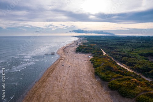 Aerial shot of beach aling the forest photo