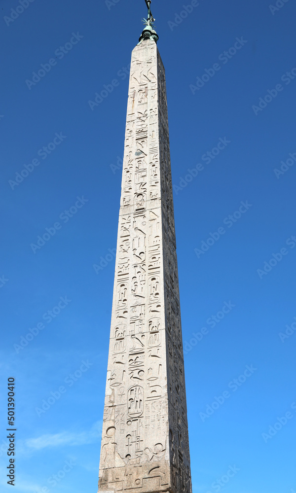 Ancient egyptian obelisk with hieroglyphs and the sky