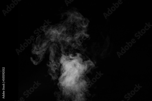 Curly white steam rising up and splashing water scattering in different directions isolated on a black background. Can be used as background, design element © Alena