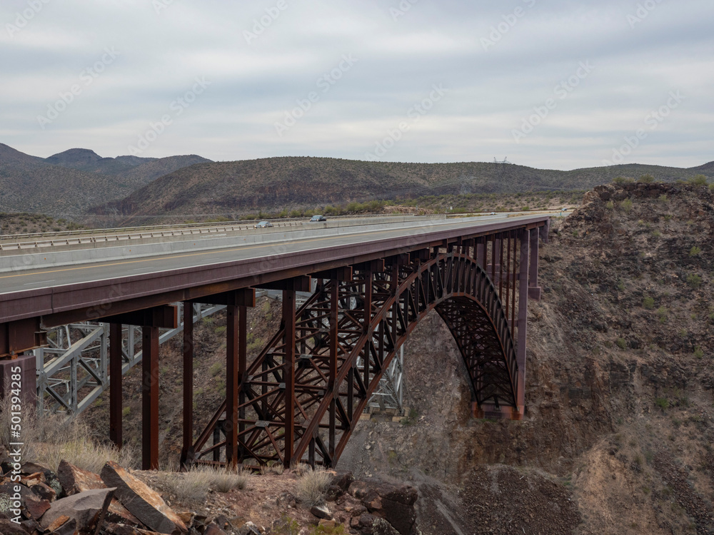 An arched bridge spanning a rugged canyon in Arizona