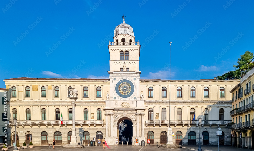 Scenic view on the astronomical clock from empty Piazza dei Signori in Padua, Veneto, Italy, Europe. Column of winged lion statue of Saint Mark background Astronomical Clock. Central square in Padova