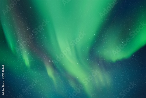 Night starry sky and Northern lights. Green aurora borealis