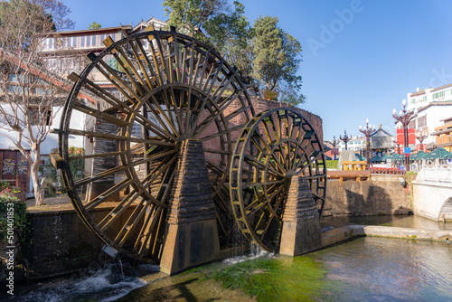 Wooden wheels of a water mill in a square of the ancient city of Lijiang, Yunnan, China