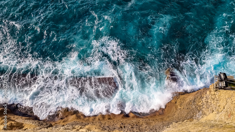 Panoramic view from Castel dell Ovo (Egg Castle) down the wall on the sea in Naples, Campania, Italy, Europe. Top view aerial photo of an seascape. Ocean wave with foam. Turquoise water Panoramic view from Castel dell Ovo (Egg Castle) down the wall on the sea in Naples, Campania, Italy, Europe. Top view aerial photo of an seascape. Ocean wave with foam. Turquoise water