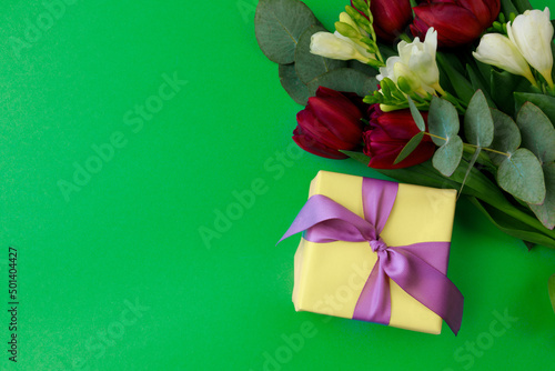 Gift box and spring flowers on color background. Stylish soft image of spring flowers. Happy womens day. Happy Mothers day.Hello Spring- Image