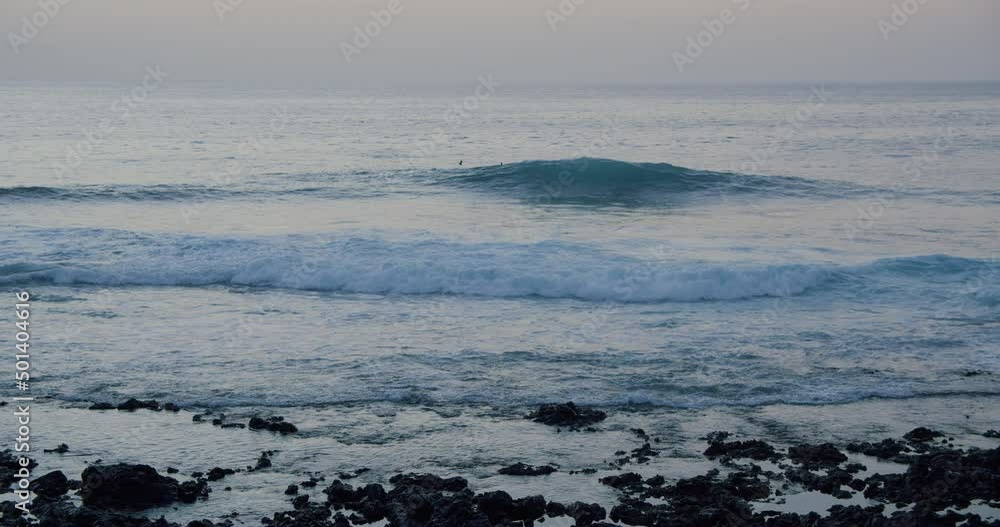 Ocean Waves Crashing on volcanic stones at sunrise Ocean Waves Crashing on volcanic stones at sunrise