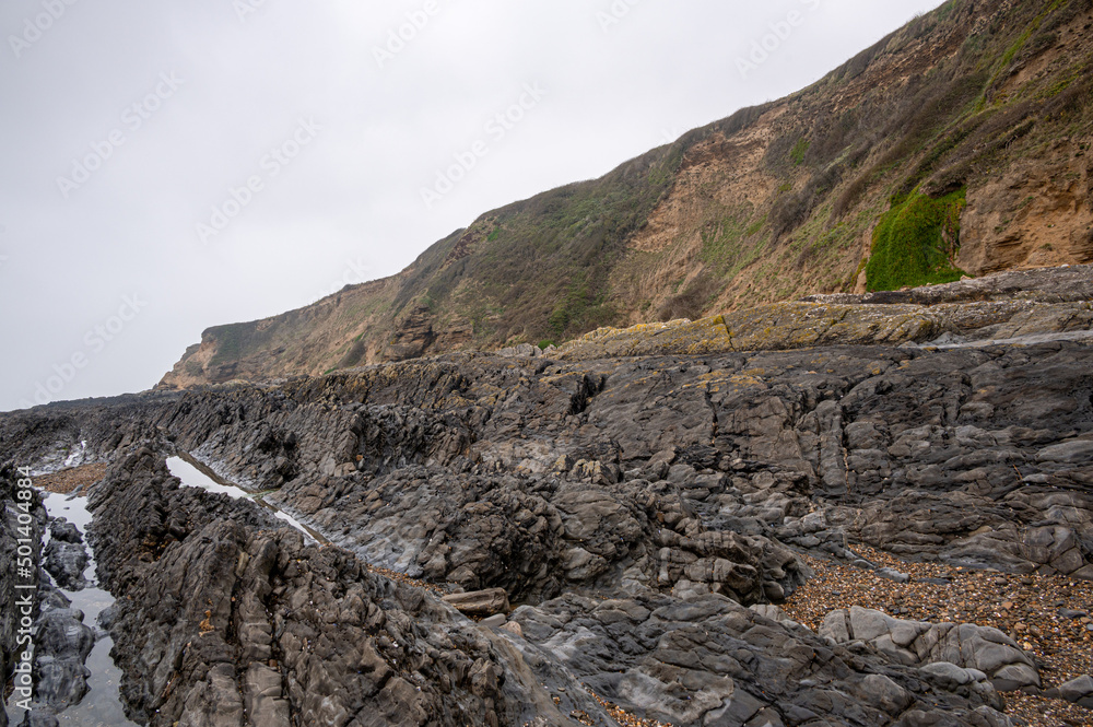 Upturned beds of Pilton shale of differing resistance that has been eroded into ridges, Sauntons Sands, Braunton, Devon