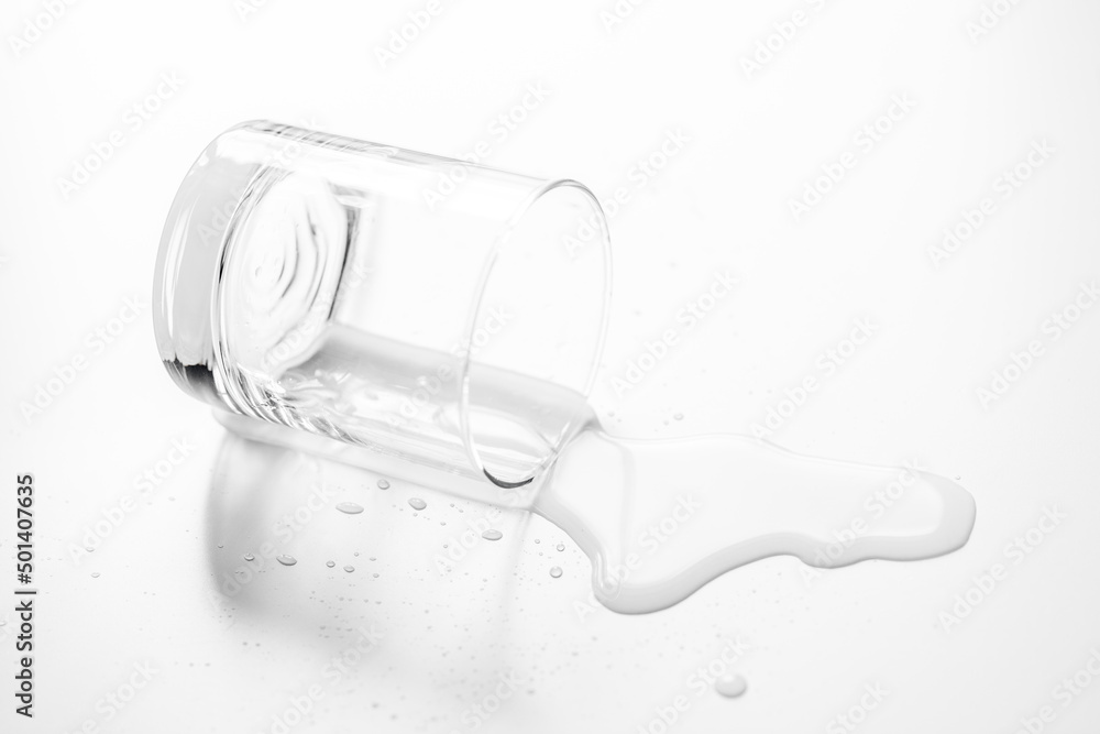 .a glass of water spilled on a white table- Image .a glass of water spilled on a white table- Image