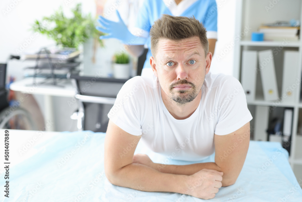 Guy at doctor appointment, nurse in manipulation room Guy at doctor appointment, nurse in manipulation room