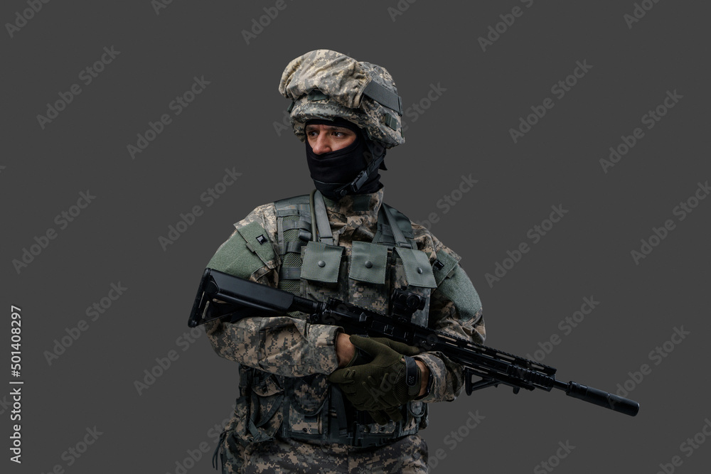 Studio shot of isolated on gray background soldier dressed in camouflage clothes. Studio shot of isolated on gray background soldier dressed in camouflage clothes.