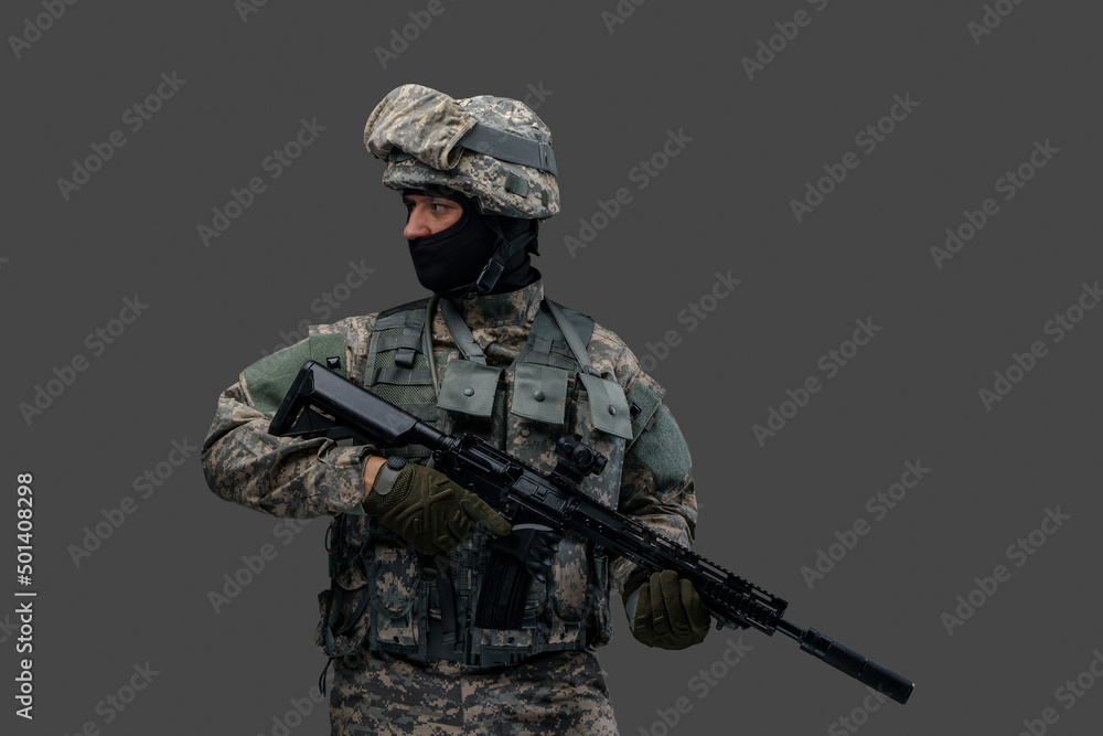 Studio shot of isolated on gray background soldier dressed in camouflage clothes. Studio shot of isolated on gray background soldier dressed in camouflage clothes.