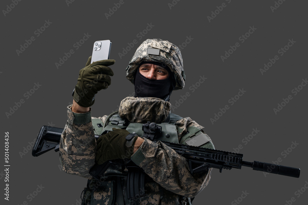 Portrait of cheerful soldier from ukraine dressed in protective uniform with cellphone. Information war. Portrait of cheerful soldier from ukraine dressed in protective uniform with cellphone. Information war.