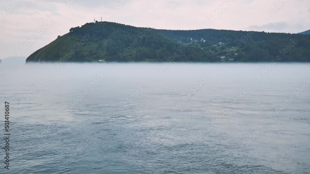 Lake Baikal in Russia in the fog on the background of the mountain. Lake Baikal in Russia in the fog on the background of the mountain.