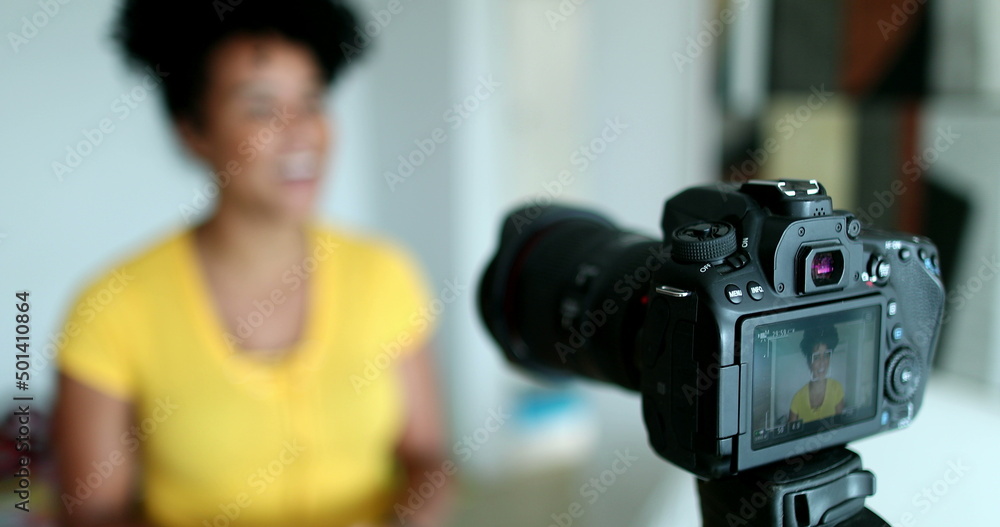 Mixed race woman giving testimony in front of camera vlogging