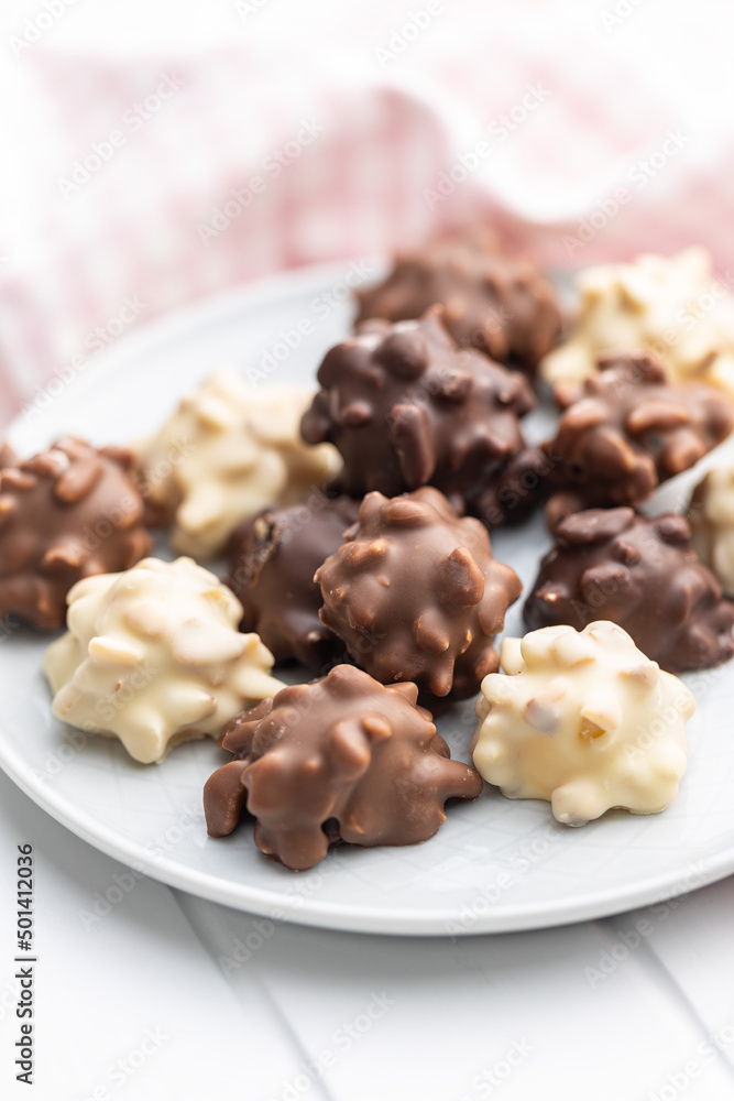 Chocolate truffles. Sweet pralines on plate. Chocolate truffles. Sweet pralines on plate.