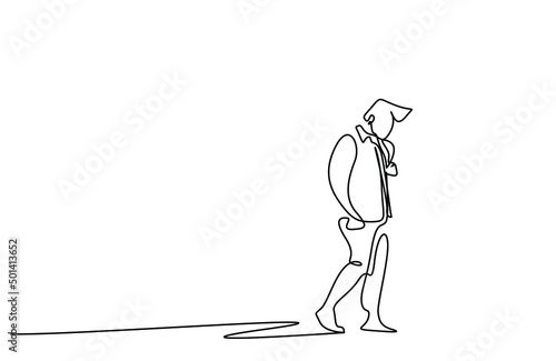 A man walking thoughtfully alone, looking at the ground outside. fired person walking sadly