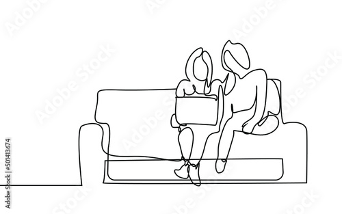 Young girls sitting on sofa at home looking at laptop together and standing relaxed. girlfriends at home hobby and lifestyle concept
