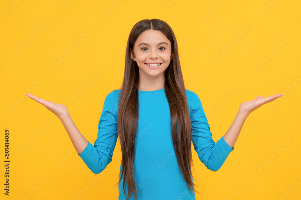 happy teen girl with long hair making choice on yellow background with copy space, choice happy teen girl with long hair making choice on yellow background with copy space, choice