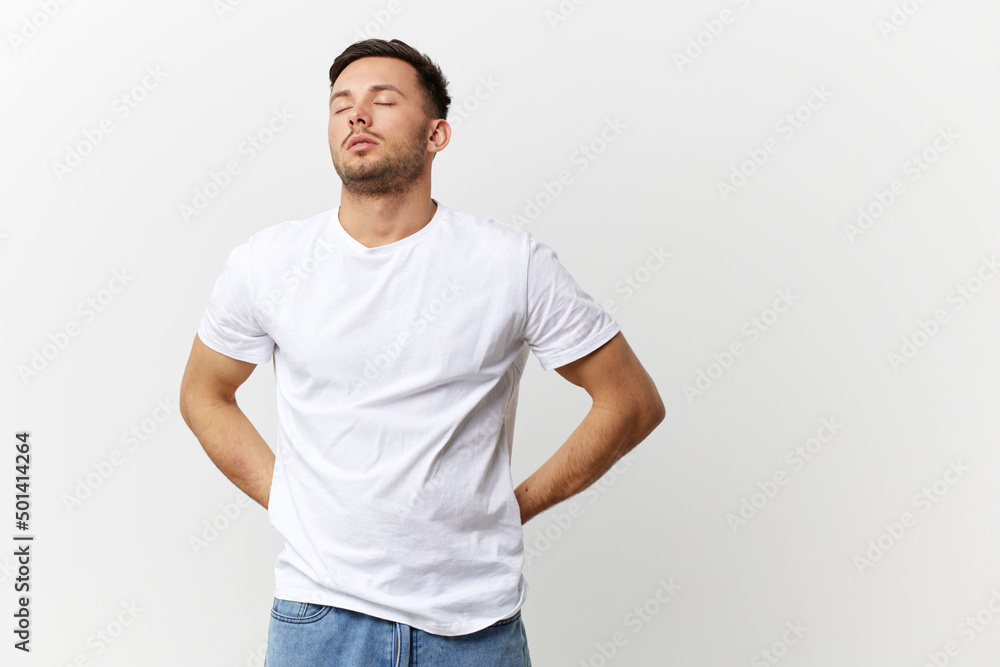 Sleepy tired tanned handsome man in basic t-shirt touch sore back close eyes posing isolated on over white studio background. Copy space Banner Mockup. People emotions Lifestyle concept Sleepy tired tanned handsome man in basic t-shirt touch sore back close eyes posing isolated on over white studio background. Copy space Banner Mockup. People emotions Lifestyle concept