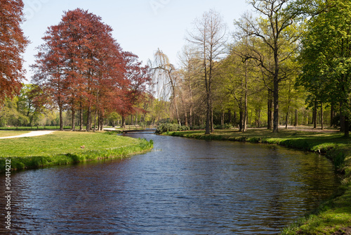 Groeneveld park with water features, hills and winding paths and trees in English landscape style.