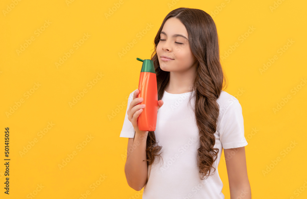 smiling teen girl with long hair smelling shampoo bottle, beauty smiling teen girl with long hair smelling shampoo bottle, beauty