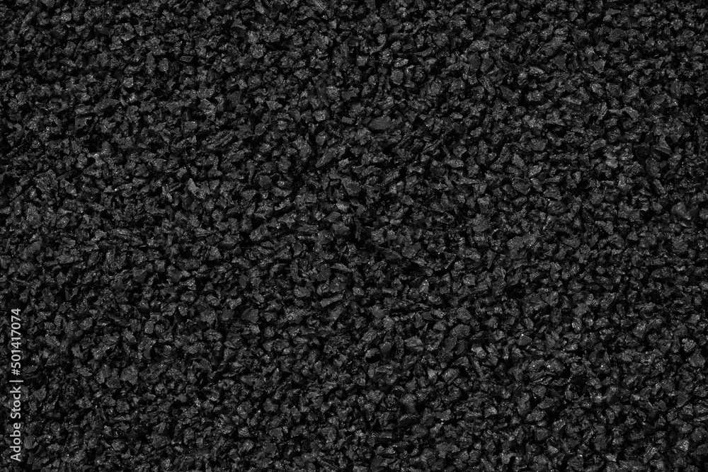 Close-up of black plastic polymer granules background Close-up of black plastic polymer granules background