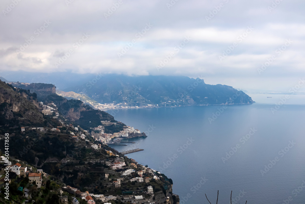 A panoramic view on the Amalfi Coast from the Path of the Gods (Sentiero Degli Dei) in Campania, Italy, Europe. Hiking trail from Praiano to Amalfi. Coastal town in the Province of Salerno. Overcast