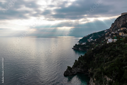 Panoramic sunset view on Amalfi Coast from the Path of the Gods (Sentiero Degli Dei) in Campania, Italy, Europe. Hiking trail from Praiano to Amalfi. Coastal town in the Province of Salerno. Overcast