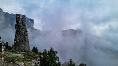 A pinnacle like rock formation on the famous Path of the Gods  Sentiero Degli Dei  on the Amalfi Coast in Campania  Italy  Europe. Hiking trail to San Lazzaro is covered with mystical fog.
