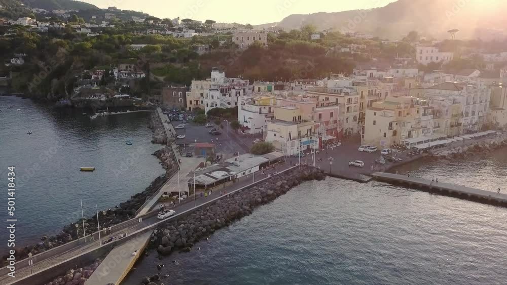 White car is driving over the bridge connects Ischia Island surrounded by sea White car is driving over the bridge connects Ischia Island surrounded by sea