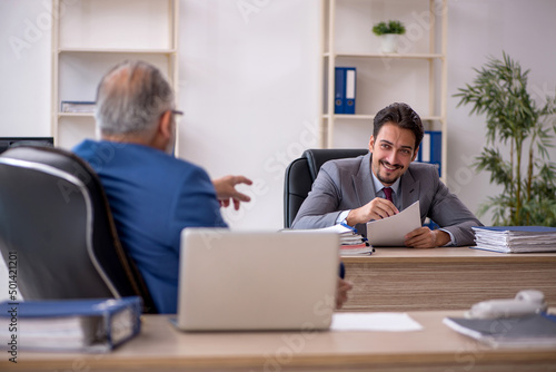 Two male colleagues working in the office