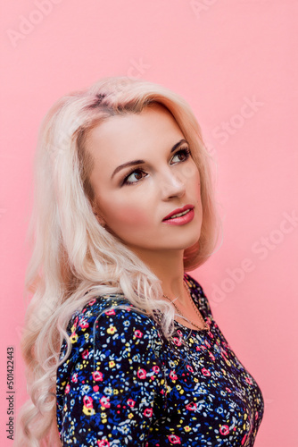 Young beautiful blonde in retro style on a pink background photo