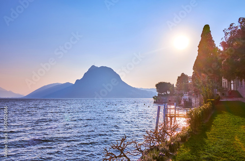 The pleasant evening time spending in the park on the shore of Lugano Lake, Lugano, Switzerland photo