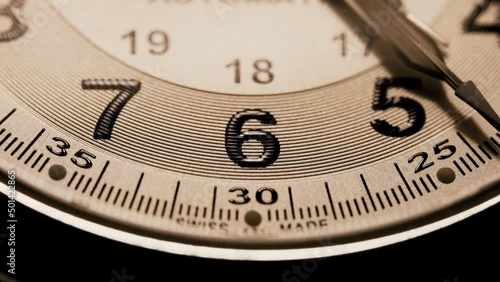 Macro of a sweeping seconds hand on a mechanical wristwatch