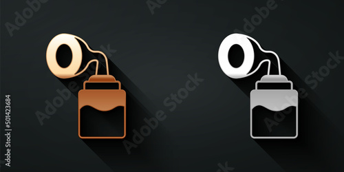 Gold and silver Breast pump icon isolated on black background. Long shadow style. Vector