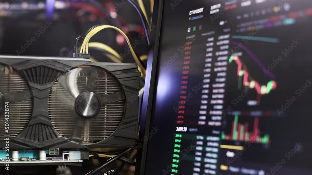 Graphics cards in rig for ethereum mining farm on background Stock Market ETH Chart.