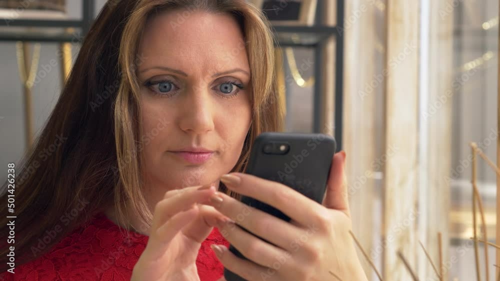 Woman hold and touching mobile screen writing a message Woman hold and touching mobile screen writing a message