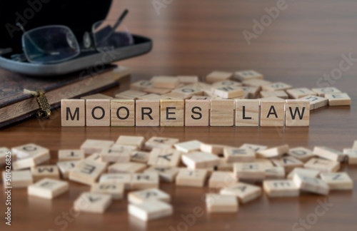 Quadro su tela moores law word or concept represented by wooden letter tiles on a wooden table
