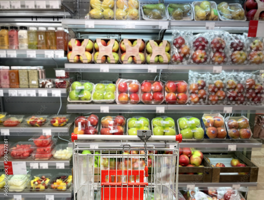 buying vegetables and fruits at the market.empty grocery cart in an empty supermarket buying vegetables and fruits at the market.empty grocery cart in an empty supermarket
