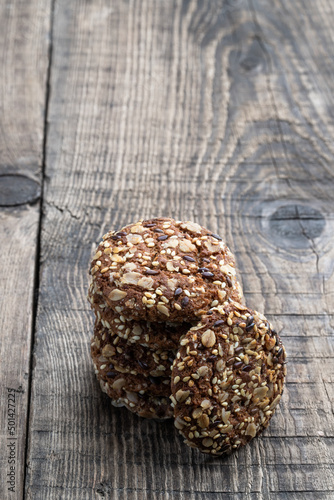 Healthy fitness cookies from sunflower seeds and sesame seeds with flax seeds on wooden table