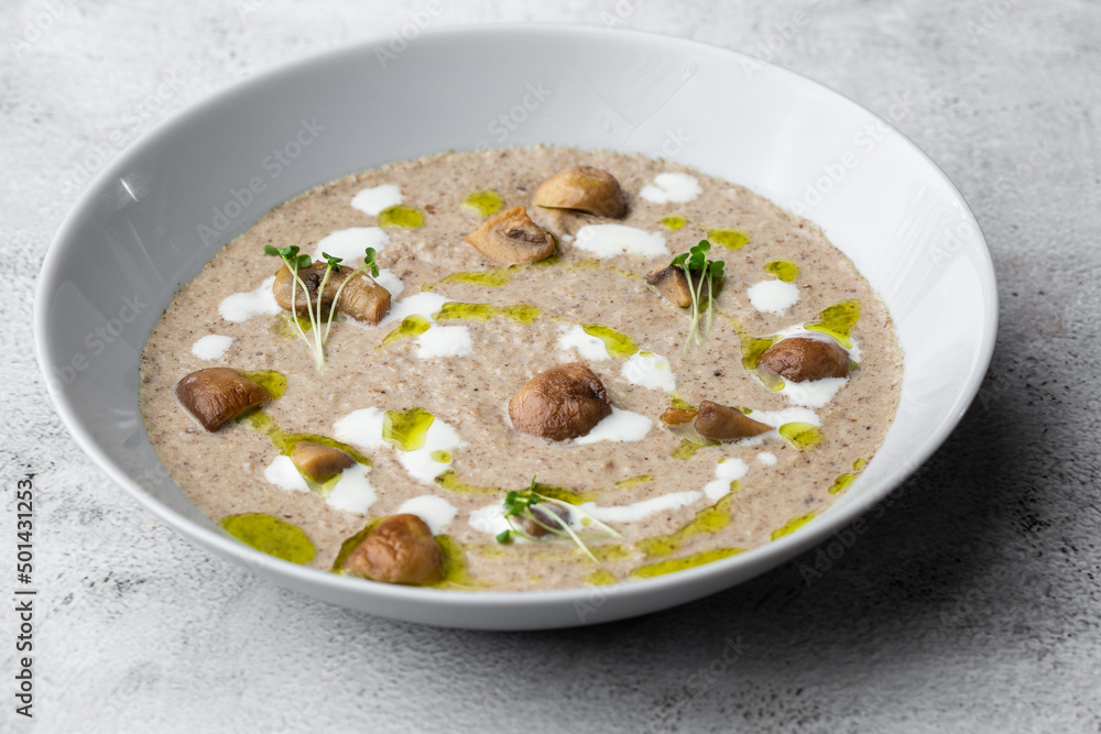 A bowl of Mushroom Cream Soup with fried champignons. Winter, autumn hot soup concept
