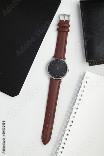 Watches with brown leather strap on white office desk