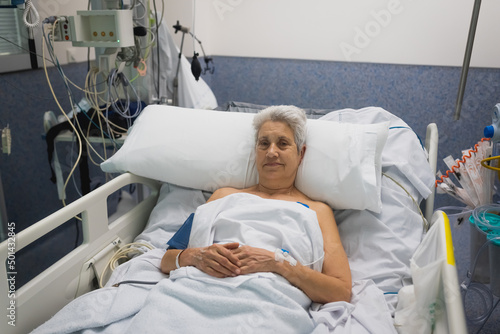  digital vital signs of measuring heart and blood pressure monitor with elderly patient sleep on the bed in hospital ward room photo