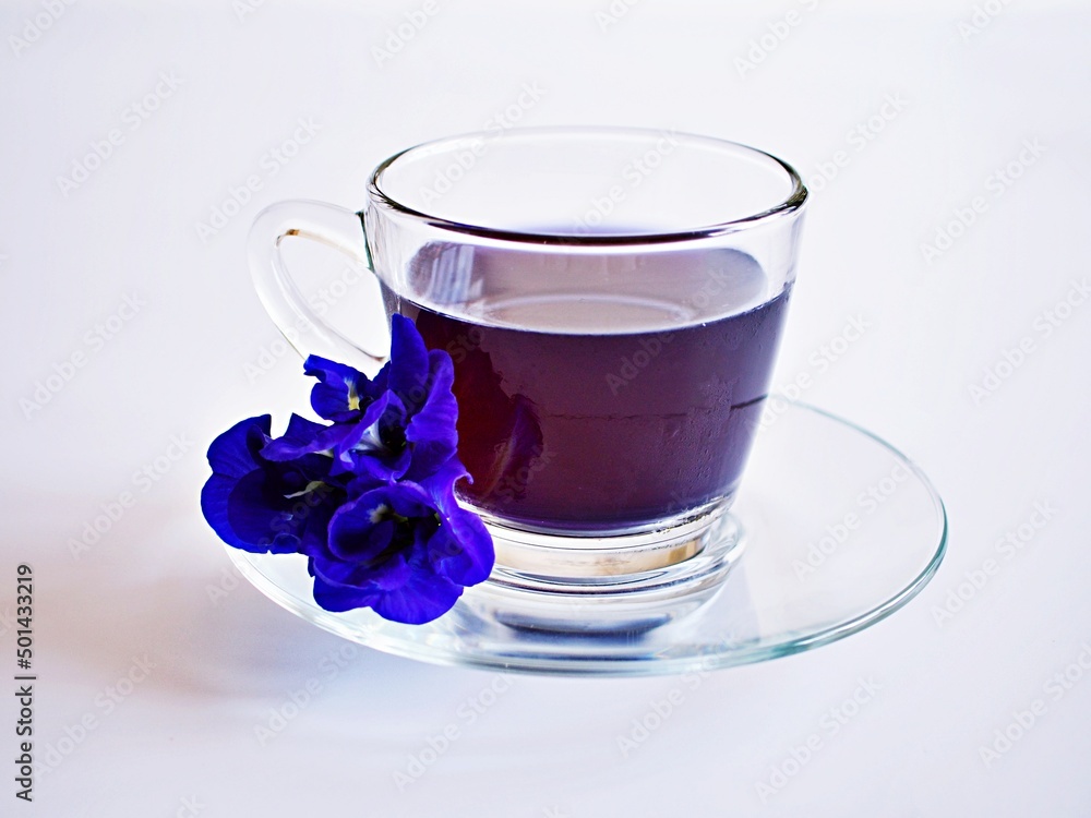 Cup of tea with blue flowers isolated on white background herb tea Cup of tea with blue flowers isolated on white background herb tea